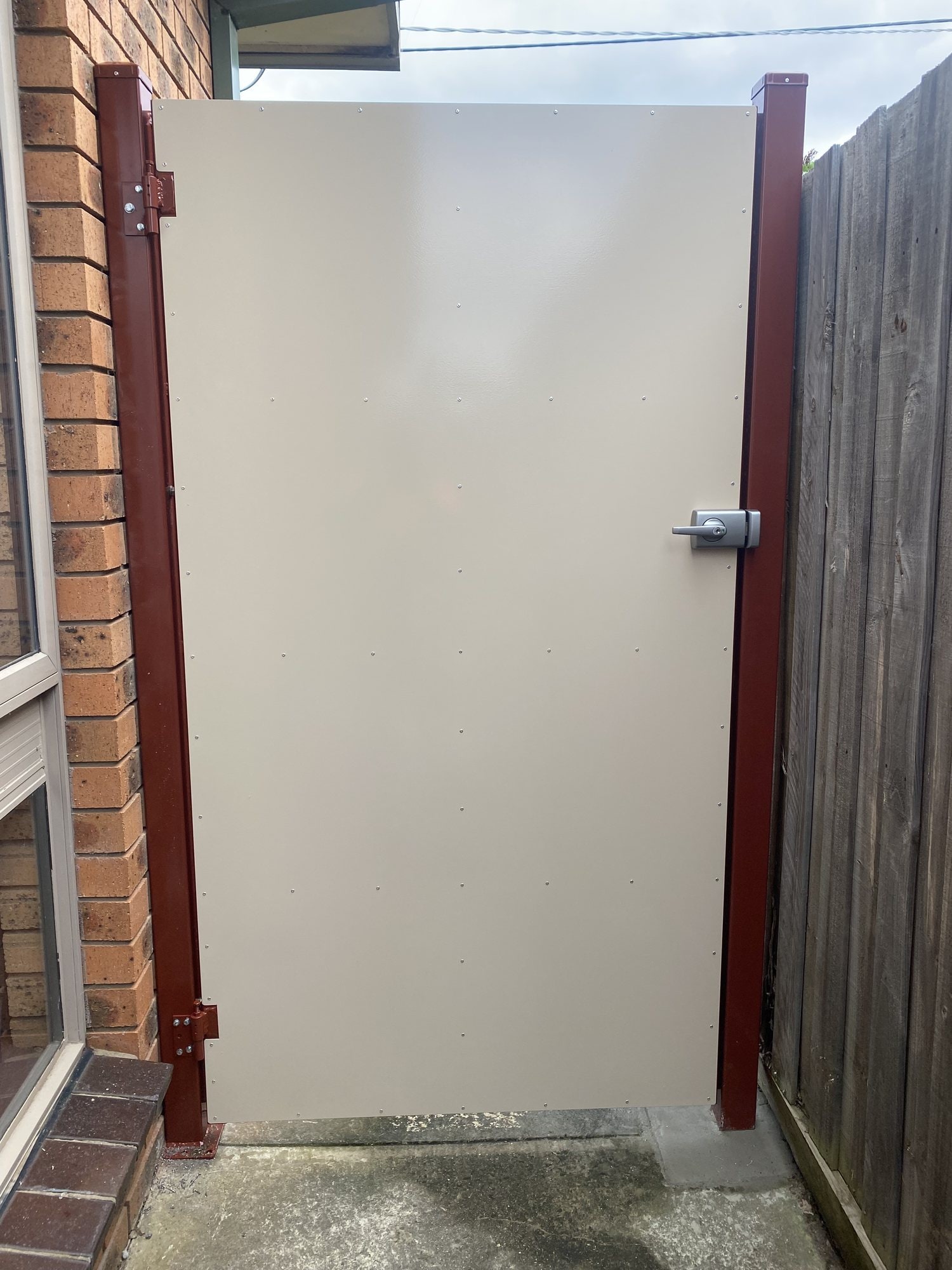 Custom cream metal access door with red frame