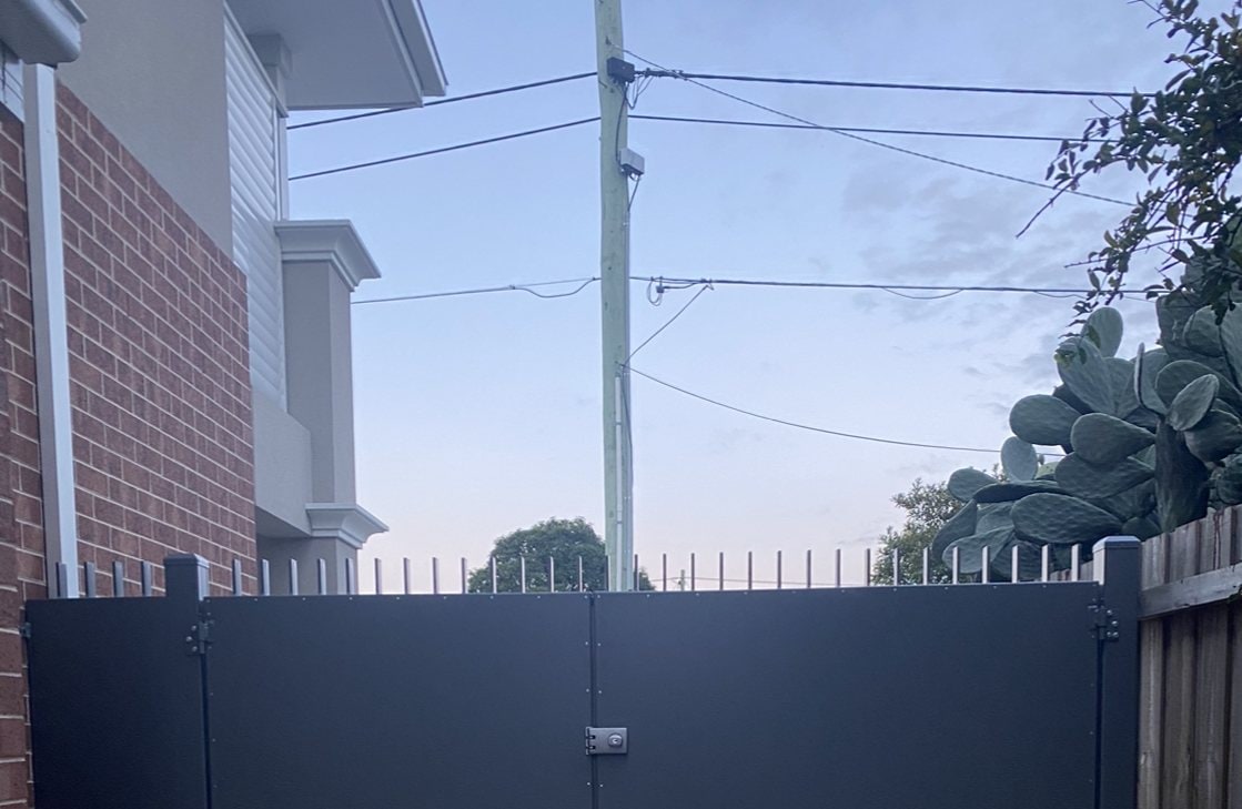 Solid grey metal privacy double gates