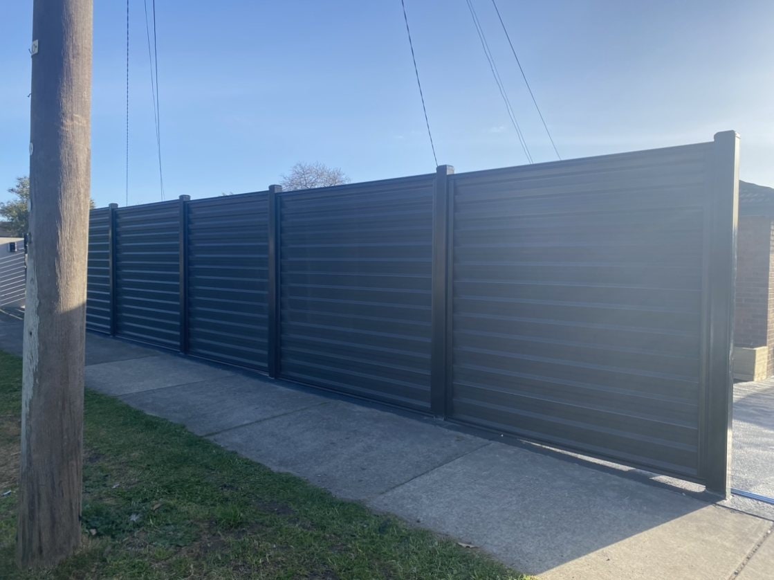 Dark grey horizontal slat metal privacy fence