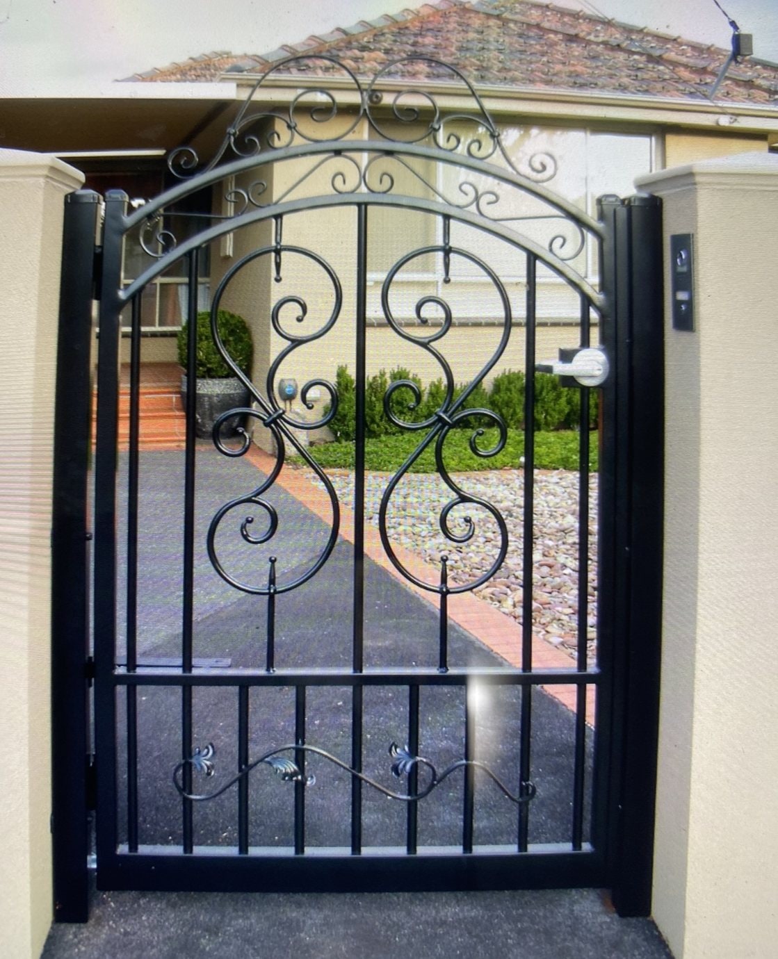 Black ornamental scrollwork pedestrian gate