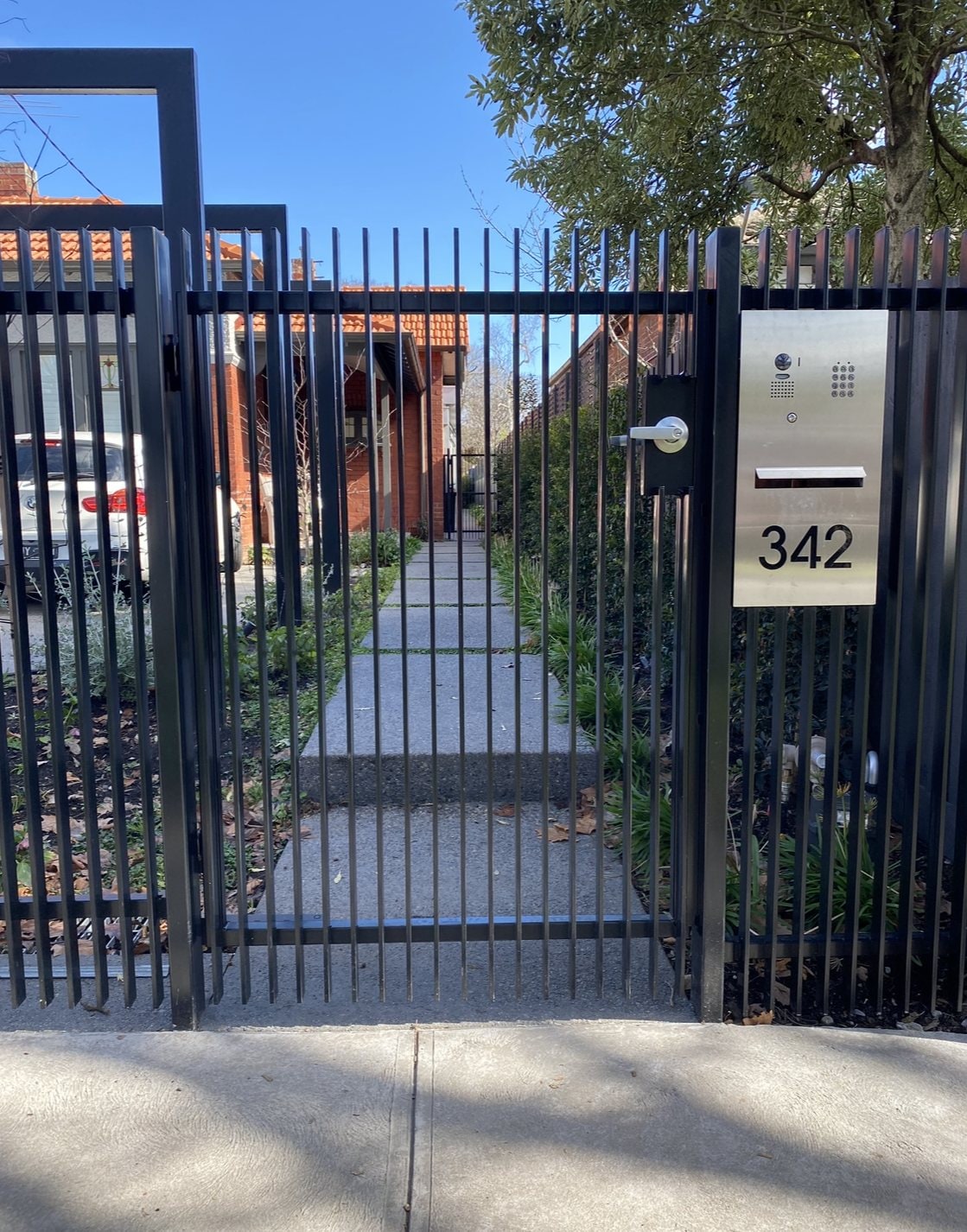 Black palisade pedestrian gate with letterbox numbered 342