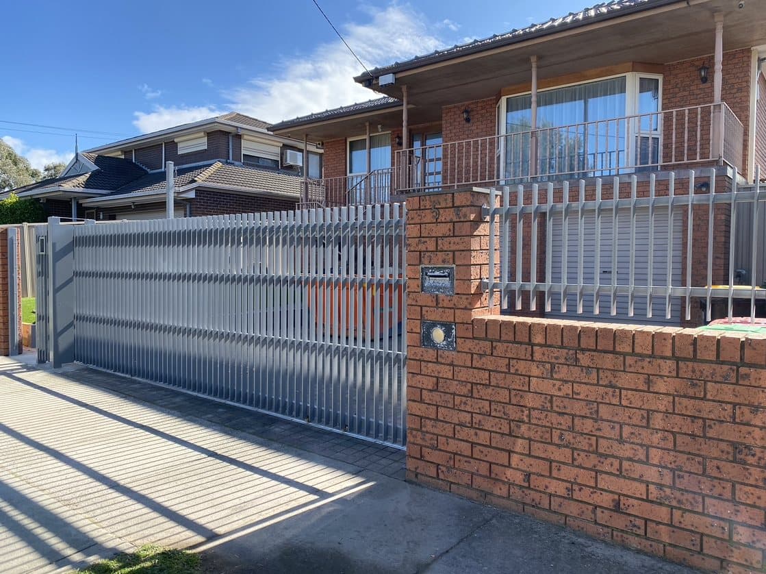 Galvanised sliding gate and powder-coated metal fencing